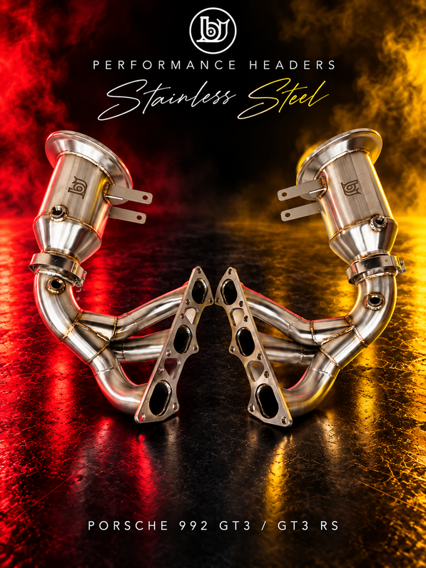 BJG stainless steel performance header pair for Porsche 992 GT3 and GT3 RS, showing six primary runners, flanges and removable outlet sections with red and yellow lighting.